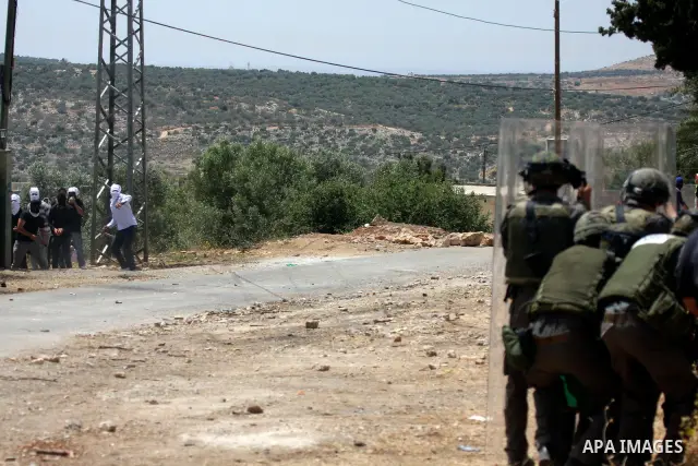 Palestinian protesters throw stones at Israeli soldiers during clashes in the northern West Bank village of Kufr Qaddum, near the Jewish settlement of Kdumim, on May 25, 2012. Photo by Wagdi Eshtayah