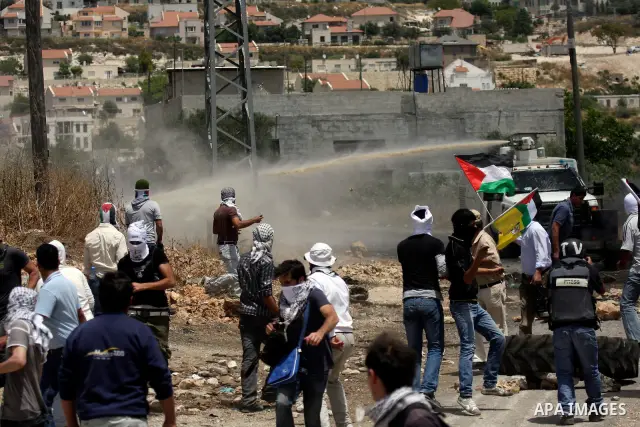 Israeli truck spray foul smelling water towards Palestinian protesters during clashes in the northern West Bank village of Kufr Qaddum, near the Jewish settlement of Kdumim, on May 25, 2012. Photo by Wagdi Eshtayah