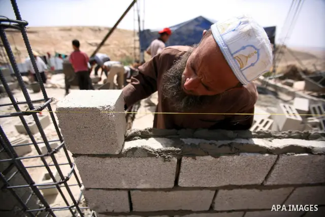 Palestinian workers build homes for Palestinians in the West Bank City of Hebron, on May 26, 2012 Palestinians whose houses were destroyed during Israeli military operations in West bank. Photo by Mamoun Wazwaz