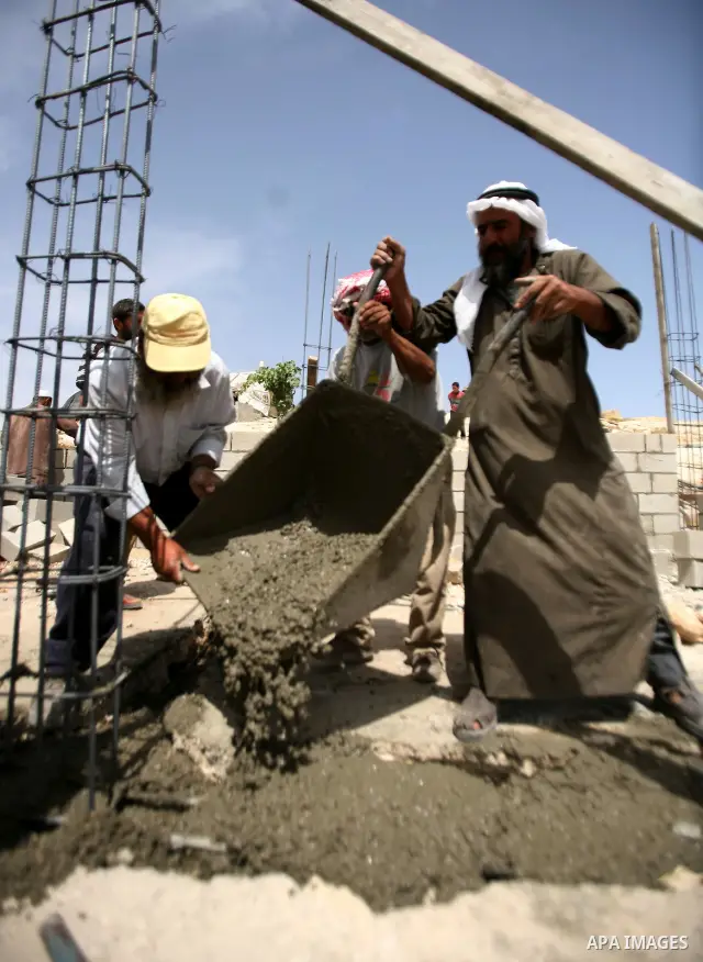 Palestinian workers build homes for Palestinians in the West Bank City of Hebron, on May 26, 2012 Palestinians whose houses were destroyed during Israeli military operations in West bank. Photo by Mamoun Wazwaz