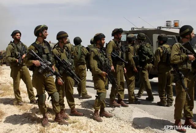 Palestinian protesters run for cover as Israeli forces fire in the air to disperse the crowd during clashes that followed the setting on fire of fields of grain and olive trees by hardline settlers from the Jewish settle...