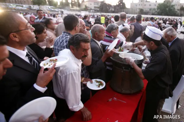 Palestinians serve food from the longest buffet table of natural and organic food, officially setting a new Guinness world record. on May 26, 2012 in Arab east jerusalem. The Palestinian banquet, prepared by Jerusalem lo...