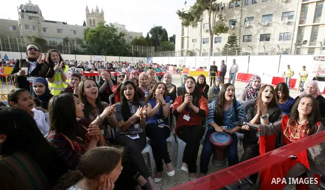 Palestinians participate a celebration in Arab east jerusalem after the longest buffet of natural and organic food registered a new Guinness world record. -- Palestinians serve food from the longest buffet table of natur...