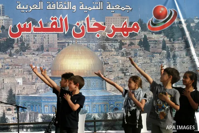 A Palestinian folkloric dance troupe performs during a celebration in Arab east jerusalem after the longest buffet of natural and organic food registered a new Guinness world record, on May 26, 2012 in Arab east jerusale...