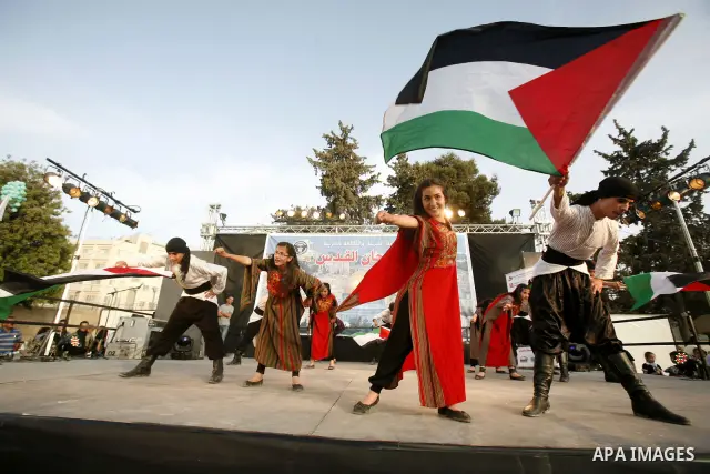 A Palestinian folkloric dance troupe performs during a celebration in Arab east jerusalem after the longest buffet of natural and organic food registered a new Guinness world record, on May 26, 2012 in Arab east jerusale...
