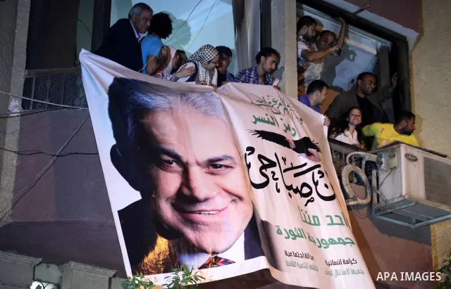 Supporters of Egyptian presidential Nasserist candidate Hamdeen Sabbahi wait to catch a glimps of him in Cairo on May 26, 2012. The apparent winners of the first round of Egypt's landmark presidential vote reached out to...