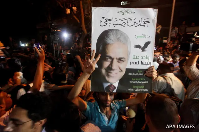 Supporters of Egyptian presidential Nasserist candidate Hamdeen Sabbahi wait to catch a glimps of him in Cairo on May 26, 2012. The apparent winners of the first round of Egypt's landmark presidential vote reached out to...