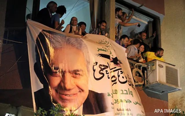 Supporters of Egyptian presidential Nasserist candidate Hamdeen Sabbahi wait to catch a glimps of him in Cairo on May 26, 2012. The apparent winners of the first round of Egypt's landmark presidential vote reached out to...