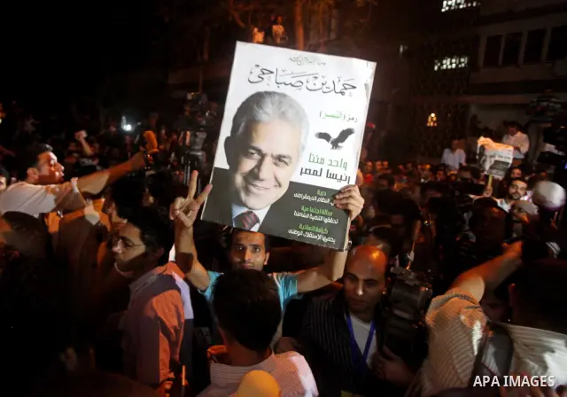Supporters of Egyptian presidential Nasserist candidate Hamdeen Sabbahi wait to catch a glimps of him in Cairo on May 26, 2012. The apparent winners of the first round of Egypt's landmark presidential vote reached out to...