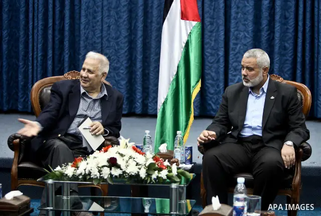 The head of Gaza's Hamas government, Ismail Haniya (C-R), meets with members of the Central Elections Commission in Gaza City on May 28, 2012 as CEC officials prepare to begin work on updating the electoral register in t...