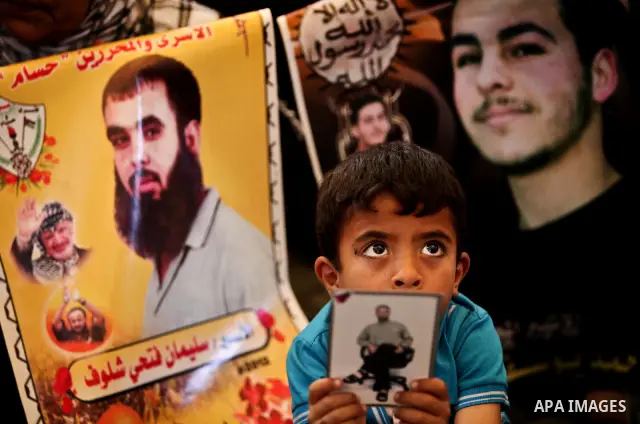Relatives of Palestinian prisoners participate a protest at the Red Cross' offices in Gaza City to call for the release of Palestinian prisoners held in Israeli jails, on May. 28, 2012. Photo by Ali Jadallah