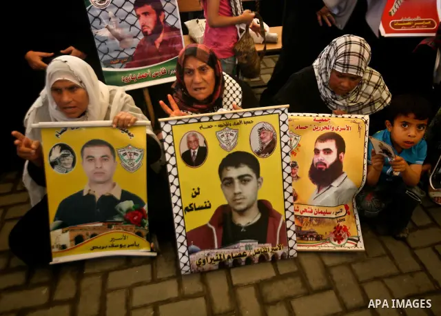 Relatives of Palestinian prisoners participate a protest at the Red Cross' offices in Gaza City to call for the release of Palestinian prisoners held in Israeli jails, on May. 28, 2012. Photo by Ali Jadallah