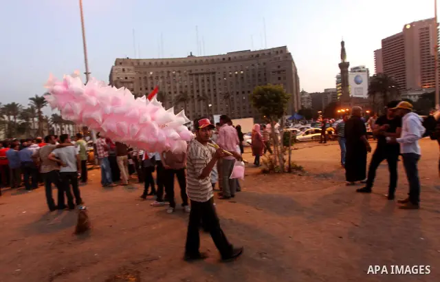 An Egyptian man sells sweets during a demonstration against presidential candidates Mohammed Morsi and Ahmed Shafiq at Tahrir Square in Cairo May 29, 2012. According to full official results released Monday by the electi...