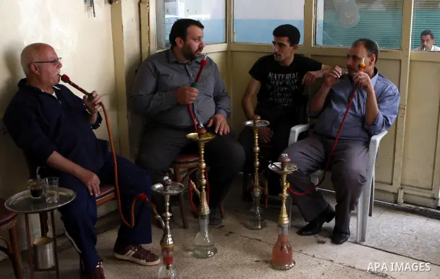 Palestinian elderly smoking water pipes at cafe in the West Bank city of Nablus, on May 30, 2012. Photo by Wajdi Eshtaya