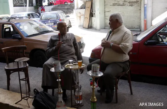 Palestinian elderly smoking water pipes at cafe in the West Bank city of Nablus, on May 30, 2012. Photo by Wajdi Eshtaya