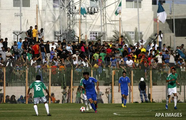 Players from Rafah Youth Club play against the players from Rafah Services Club during a football match in the League Cup of the Gaza Strip at Rafah Municipality Stadium in the southern Gaza Strip on May 30, 2012. Photo...