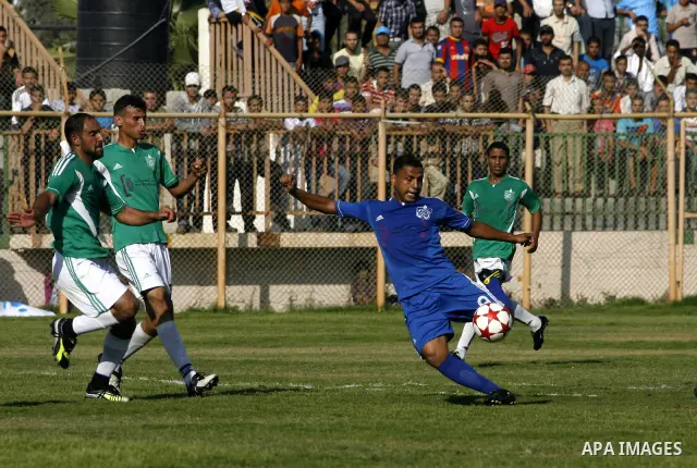 Players from Rafah Youth Club play against the players from Rafah Services Club during a football match in the League Cup of the Gaza Strip at Rafah Municipality Stadium in the southern Gaza Strip on May 30, 2012. Photo...