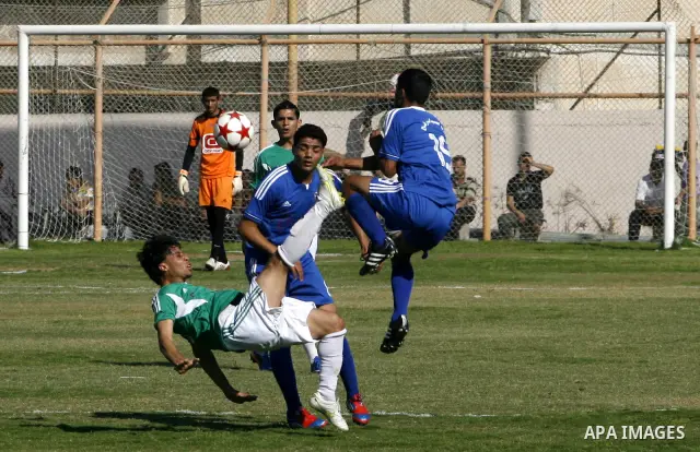 Players from Rafah Youth Club play against the players from Rafah Services Club during a football match in the League Cup of the Gaza Strip at Rafah Municipality Stadium in the southern Gaza Strip on May 30, 2012. Photo...