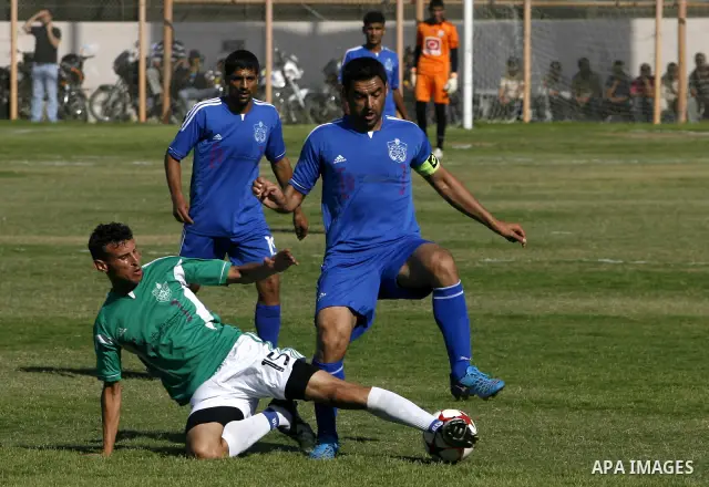 Players from Rafah Youth Club play against the players from Rafah Services Club during a football match in the League Cup of the Gaza Strip at Rafah Municipality Stadium in the southern Gaza Strip on May 30, 2012. Photo...