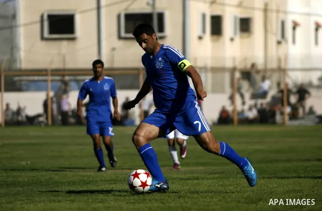 Players from Rafah Youth Club play against the players from Rafah Services Club during a football match in the League Cup of the Gaza Strip at Rafah Municipality Stadium in the southern Gaza Strip on May 30, 2012. Photo...