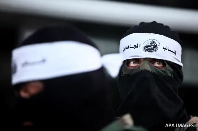 Masked Palestinian militants of a group affiliated with the Al Mujahideen Brigades attend a press conference in Gaza City, on May. 30, 2012. Photo by Ali Jadallah