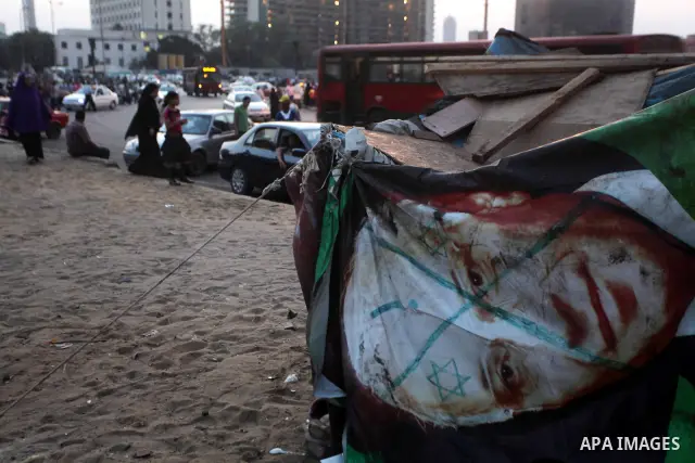 Egyptians gathers during a protest against the results of presidential elections at Tahrir Square, the focal point of the Egyptian uprising, in Cairo, Egypt, May 30, 2012. An arson attack on the headquarters of one of th...