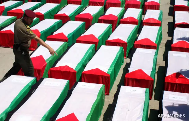Palestinian security forces carry flag-draped coffins during preparations for the funeral procession of 91 Palestinians whose remains were returned by Israel in the West Bank city of Ramallah on May 31, 2012. Israel hand...