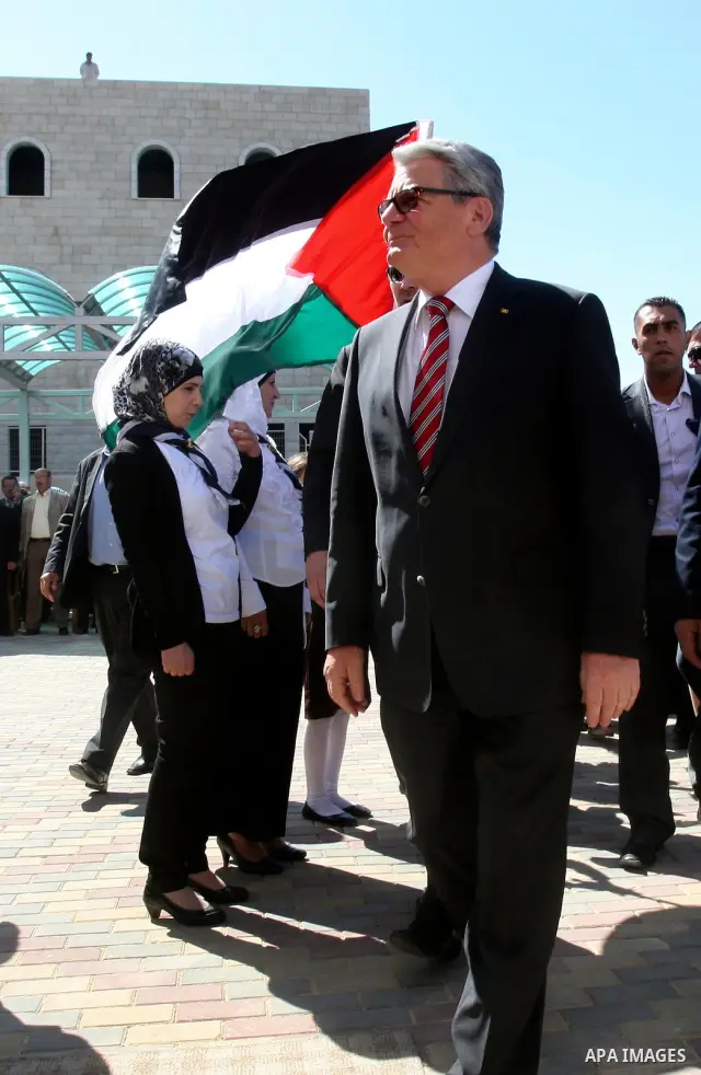 German President Joachim Gauck is greeted by Palestinian girls upon his arrival to the West Bank village of Burin, south of Nablus, to attend the inauguration of a German-funded girls' school on May 31, 2012. Photo by Wa...
