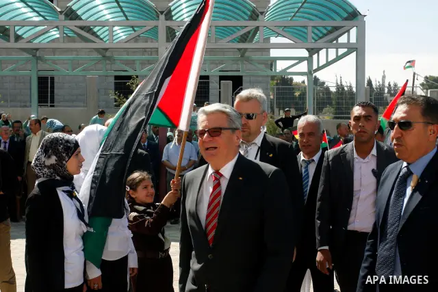 German President Joachim Gauck is greeted by Palestinian girls upon his arrival to the West Bank village of Burin, south of Nablus, to attend the inauguration of a German-funded girls' school on May 31, 2012. Photo by Wa...
