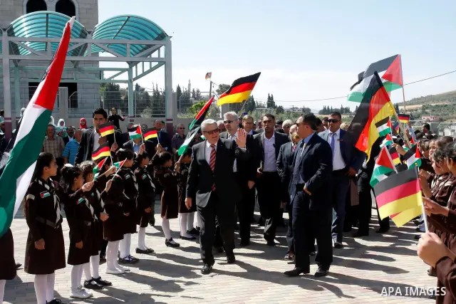 German President Joachim Gauck is greeted by Palestinian girls upon his arrival to the West Bank village of Burin, south of Nablus, to attend the inauguration of a German-funded girls' school on May 31, 2012. Photo by Wa...