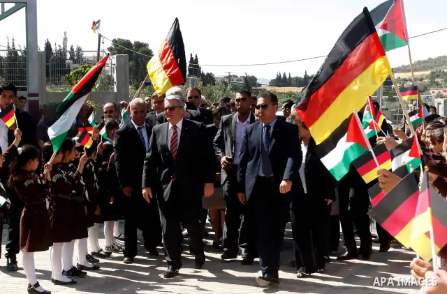 German President Joachim Gauck is greeted by Palestinian girls upon his arrival to the West Bank village of Burin, south of Nablus, to attend the inauguration of a German-funded girls' school on May 31, 2012. Photo by Wa...
