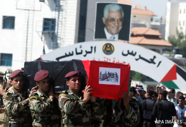 Palestinian Presidential guards carry flag-drapped coffins containing the remains of Palestinian militants during an official ceremony at the President's headquarter in the West Bank town of Ramallah, 31 May 2012. Israel...