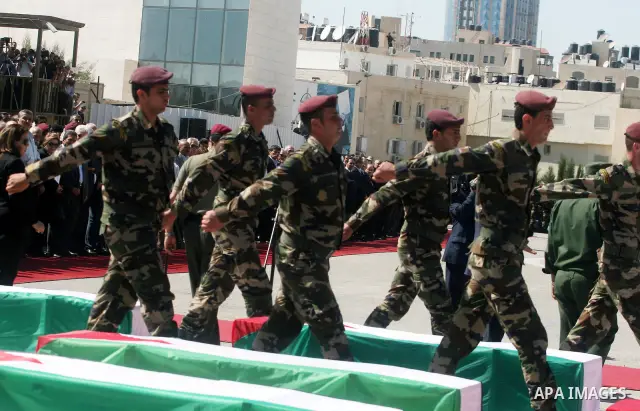 Palestinian Presidential guards carry flag-drapped coffins containing the remains of Palestinian militants during an official ceremony at the President's headquarter in the West Bank town of Ramallah, 31 May 2012. Israel...