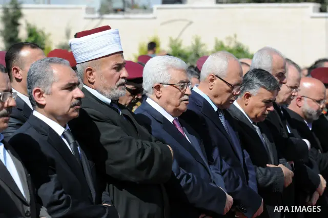 Palestinian President Mahmoud Abbas prays with officials over flag-draped coffins during an official ceremony marking the return of the remains of dozens of Palestinians militants in the West Bank city of Ramallah May 31...