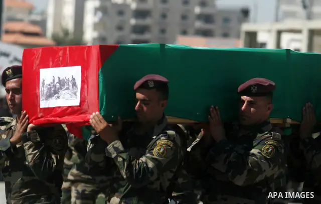 Palestinian Presidential guards carry flag-drapped coffins containing the remains of Palestinian militants during an official ceremony at the President's headquarter in the West Bank town of Ramallah, 31 May 2012. Israel...