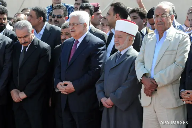 Palestinian President Mahmoud Abbas prays with officials over flag-draped coffins during an official ceremony marking the return of the remains of dozens of Palestinians militants in the West Bank city of Ramallah May 31...