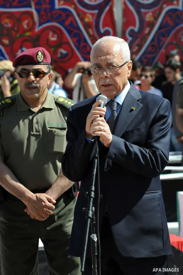 Secretary General of the Palestinian presidency, Tayeb Abdel Rahim speaks during an official ceremony marking the return of the remains of dozens of Palestinians militants in the West Bank city of Ramallah May 31, 2012....