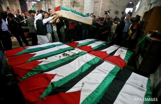 Palestinians pray next to flag-covered coffins containing the remains of Palestinian militants in a mosque in Gaza City May 31, 2012. The remains of 91 Palestinian militants whose attacks killed hundreds of Israelis over...