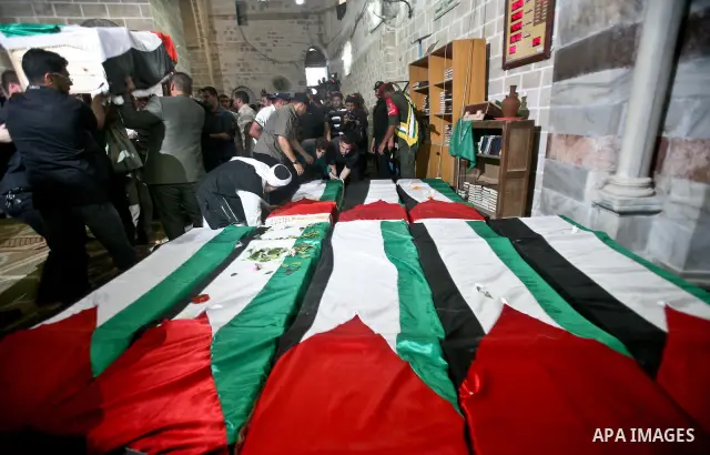 Palestinians pray next to flag-covered coffins containing the remains of Palestinian militants in a mosque in Gaza City May 31, 2012. The remains of 91 Palestinian militants whose attacks killed hundreds of Israelis over...