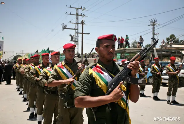 Hamas guard of honour at attention as they wait for the arrival of the remains of 12 Palestinians killed during anti-Israeli attacks, near the Erez crossing in the northern Gaza Strip on May 31, 2012. Israel handed over...