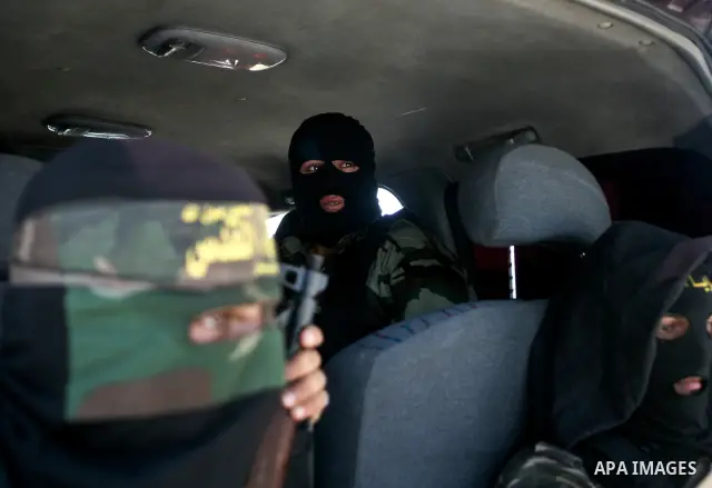 Palestinian Islamic Jihad militants attend the funeral of 12 Palestinian militants transferred from Israel, in Gaza City, Thursday, May 31, 2012. Israel transferred the bodies in an effort to induce Palestinian President...