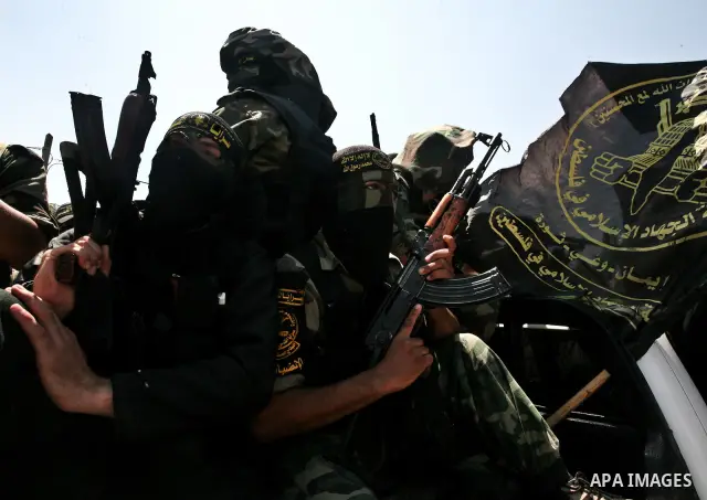 Palestinian Islamic Jihad militants attend the funeral of 12 Palestinian militants transferred from Israel, in Gaza City, Thursday, May 31, 2012. Israel transferred the bodies in an effort to induce Palestinian President...
