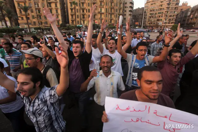 Syrians living in Egypt shout slogans as they protest against the weekend massacre of Houla, in front of the Syrian embassy in Cairo, Egypt, 31 May 2012. A massacre was reported in the central Syrian city of Houla over t...