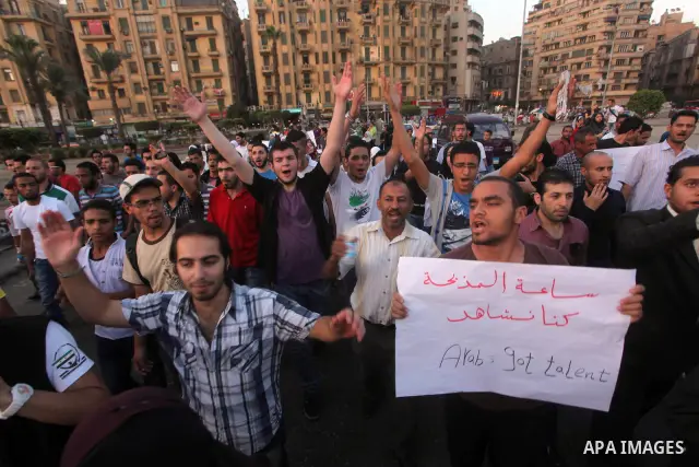 Syrians living in Egypt shout slogans as they protest against the weekend massacre of Houla, in front of the Syrian embassy in Cairo, Egypt, 31 May 2012. A massacre was reported in the central Syrian city of Houla over t...