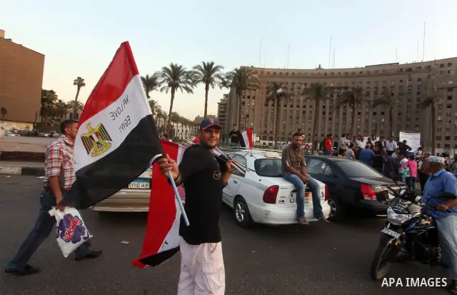 Egyptian Protester waves flag during a protest against candidate Ahmed Shafiq, at Tahrir Square in Cairo May 31, 2012. The prospect of Shafiq succeeding Hosni Mubarak as president of Egypt is a nightmare for revolutionar...