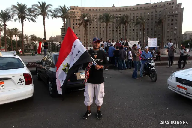Egyptian Protester waves flag during a protest against candidate Ahmed Shafiq, at Tahrir Square in Cairo May 31, 2012. The prospect of Shafiq succeeding Hosni Mubarak as president of Egypt is a nightmare for revolutionar...