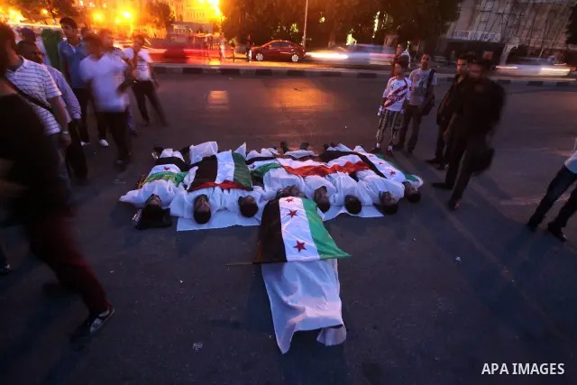 Protesters show solidarity with victims of massacre of Houla during a protest in front of the Syrian embassy in Cairo, Egypt, 31 May 2012. A massacre was reported in the central Syrian city of Houla over the weekend, how...