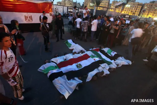 Protesters show solidarity with victims of massacre of Houla during a protest in front of the Syrian embassy in Cairo, Egypt, 31 May 2012. A massacre was reported in the central Syrian city of Houla over the weekend, how...