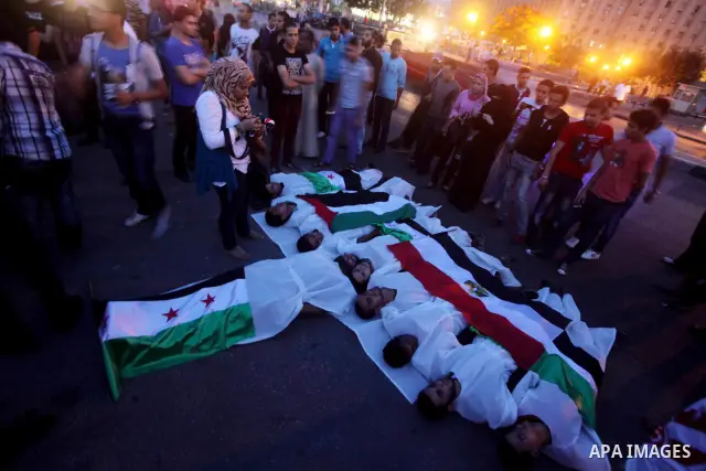 Protesters show solidarity with victims of massacre of Houla during a protest in front of the Syrian embassy in Cairo, Egypt, 31 May 2012. A massacre was reported in the central Syrian city of Houla over the weekend, how...
