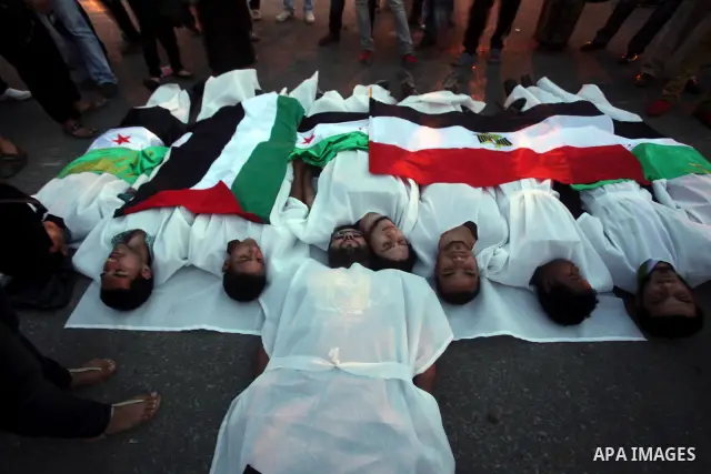 Protesters show solidarity with victims of massacre of Houla during a protest in front of the Syrian embassy in Cairo, Egypt, 31 May 2012. A massacre was reported in the central Syrian city of Houla over the weekend, how...